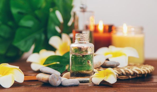 Spa oils with plumeria flowers. Selective focus. Natural.