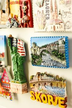 Many magnets on fridge from different countries, travel concept