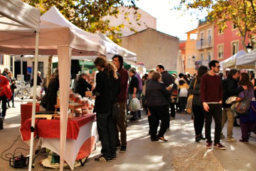 Elche, Alicante, Spain- December 1, 2018: People buying in the local ecological market in the main square of the Raval neighborhood in Elche