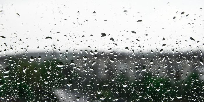 rain drops on a window in the background of the beautiful sky, copy space for text