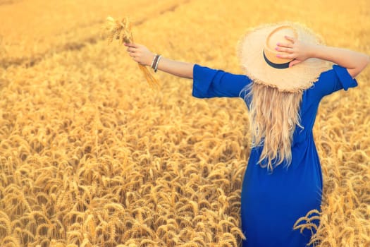 Woman in a wheat field. Selective focus. Nature.