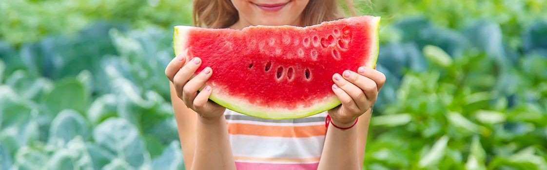 A child on a picnic eats a watermelon. Selective focus. food.