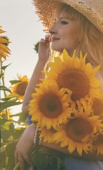 Woman in a field of sunflowers. Selective focus. nature.