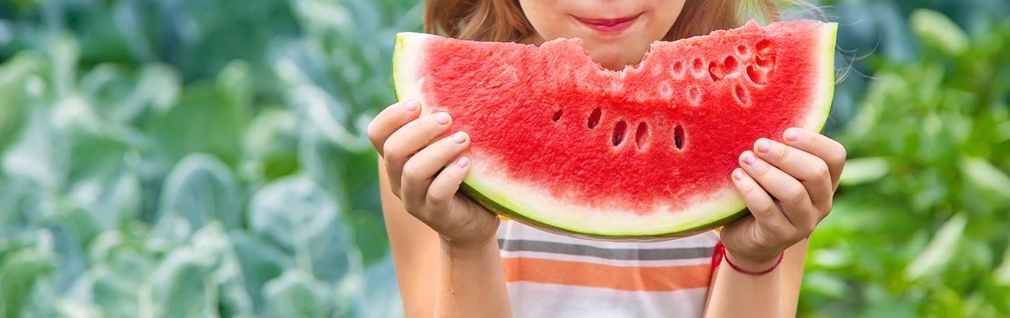 A child on a picnic eats a watermelon. Selective focus. food.
