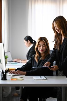Two asian businesswomen working together at office.