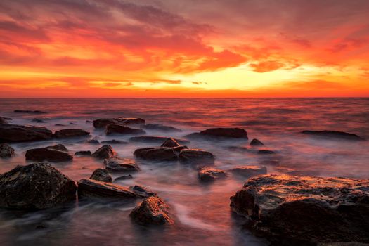 Stunning fire sunrise over the sea. Horizontal view
