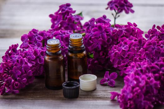 Lilac essential oil in a small bottle. Selective focus. Nature.