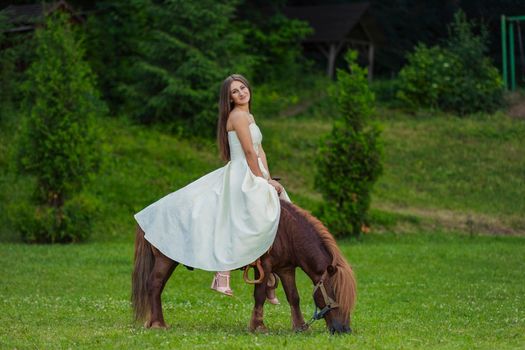 girl riding a pony in the park