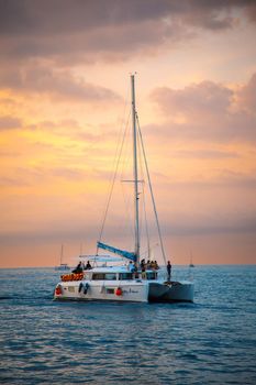 Sailing boat during sunset at Promthep Cape in Phuket peninsula, Thailand. High quality photo