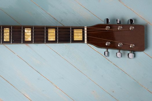 view from above of acoustic guitar on wooden background, copy space.