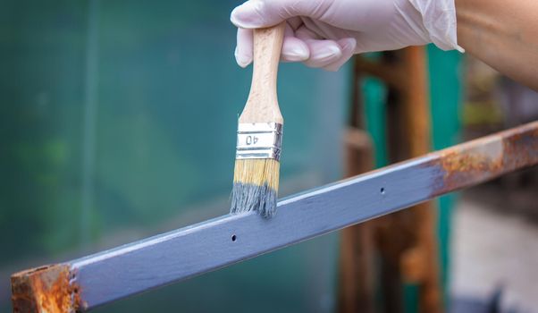 paint the iron frame with gray paint. selective focus