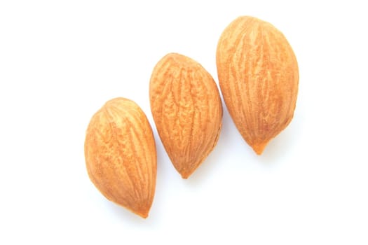 A softer, usually edible part of a nut, seed, or fruit stone contained within its hard shell. Ripe apricot kernels, taste of warm summer.