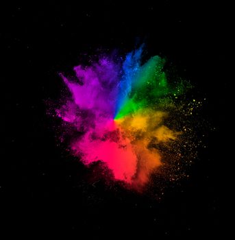 Colorful rainbow holi paint powder explosion isolated on black