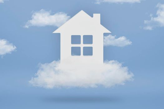 Dream House. The concept of buying a dream home. White house in the clouds on a blue sky background. Purchase of real estate, real estate loan