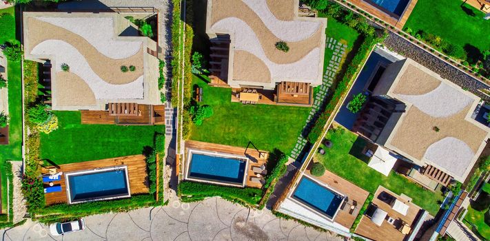 Swimming Pool viewed from above. Top down view of modern luxury villa with swimming pool