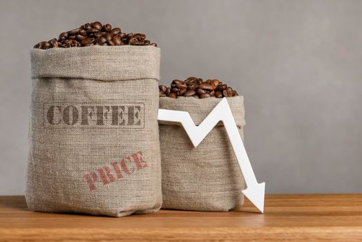 Lower prices for black coffee beans. Poor harvest of coffee beans, world food crisis. Decline in the cost of coffee futures and derivatives.Decrease graph, arrow pointing down.