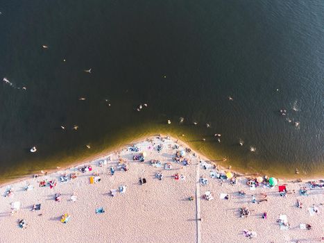 Aerial view on coastline. Summer seascape in sunny day. Top view of people on the beach from drone. Summer seascape from air. Travel image