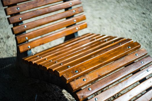 Wooden garden chair outdoor in the summer park