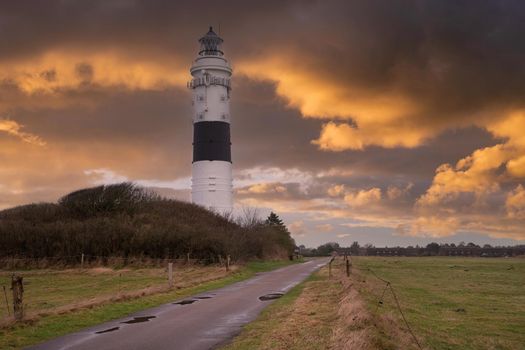 Panoramic image of Kampen lighthouse against dramatic sky, Sylt, North Frisia, Germany 