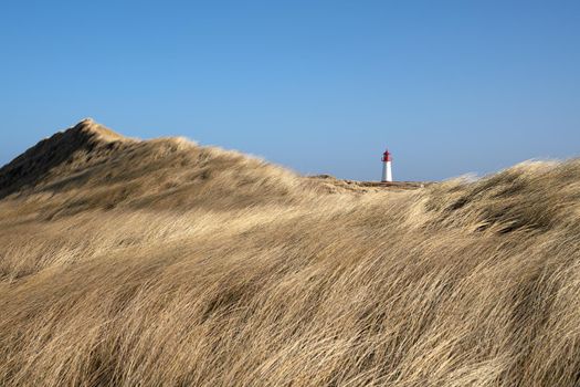 Panoramic image of List West lighthouse against blue sky, Sylt, North Frisia, Germany 