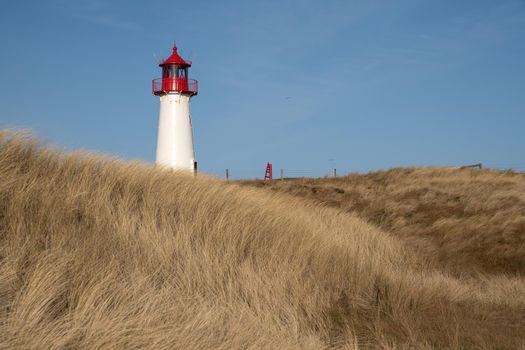 Panoramic image of List West lighthouse against blue sky, Sylt, North Frisia, Germany 