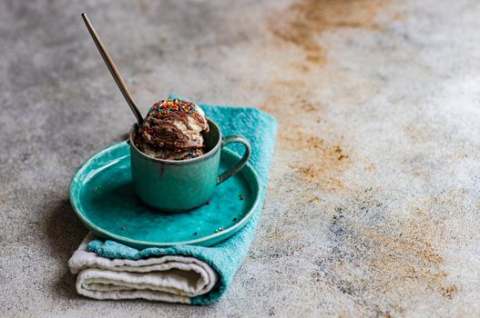 Sweet homemade chocolate ice cream with nuts served in a cup