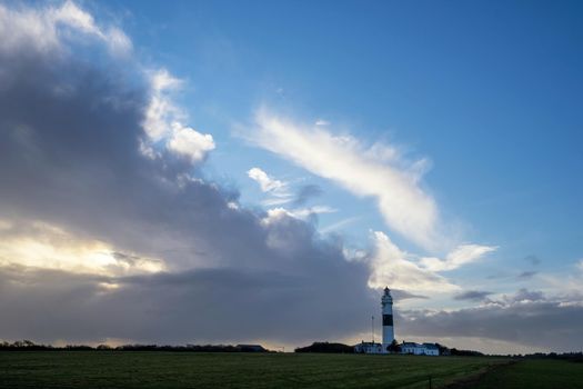 Panoramic image of Kampen lighthouse against dramatic sky, Sylt, North Frisia, Germany 