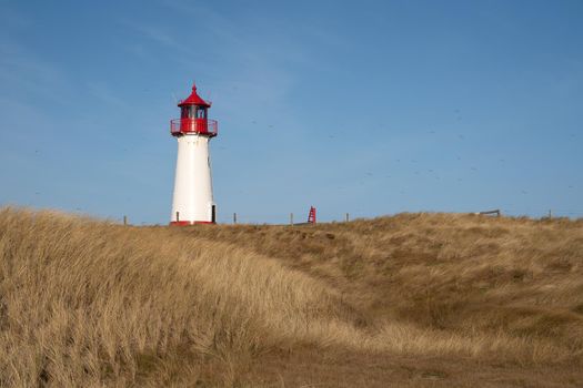 Panoramic image of List West lighthouse against blue sky, Sylt, North Frisia, Germany 