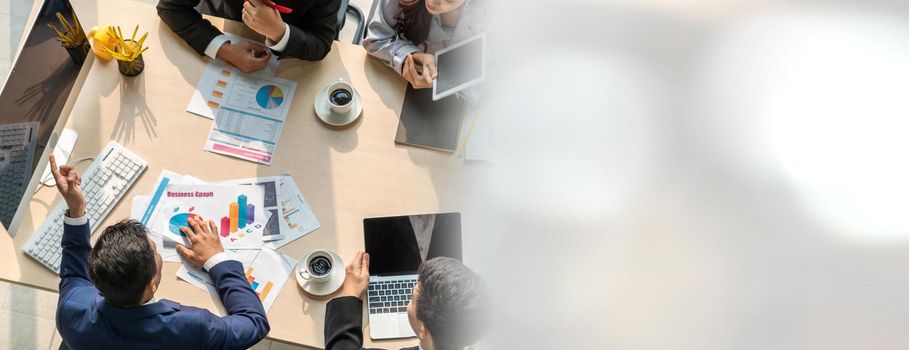 Business people group meeting shot from top widen view in office . Profession businesswomen, businessmen and office workers working in team conference with project planning document on meeting table .