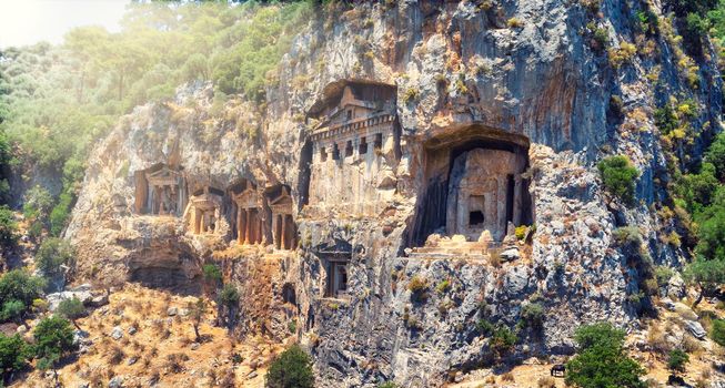 The ancient ruins of Myrna city close to Antalya Turkey, with creepy rock tombs lightened by sun going down. High quality photo
