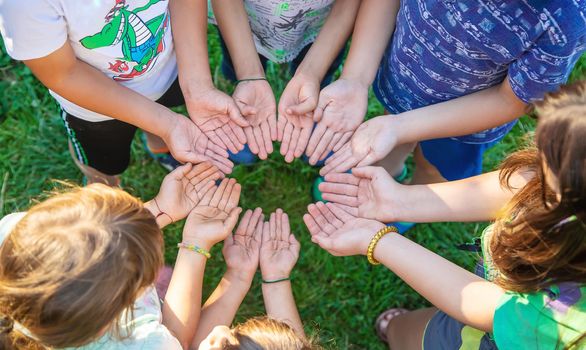 The children put their hands together. Selective focus. people.