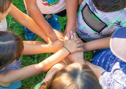 The children put their hands together. Selective focus. people.