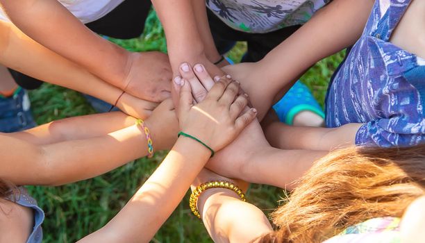 The children put their hands together. Selective focus. people.