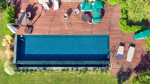 Swimming Pool viewed from above. Top down view of modern luxury villa with swimming pool. Aerial luxury resort landscape, resort hotel swimming pool, vacation