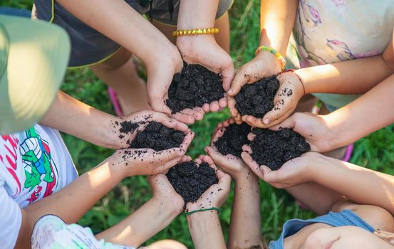 Children hold the earth in their hands. Selective focus. nature.