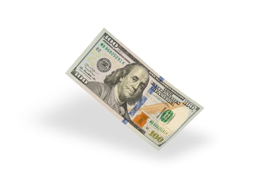 Hundred dollar bill falling casting shadow, half-folded bill close-up on white background.