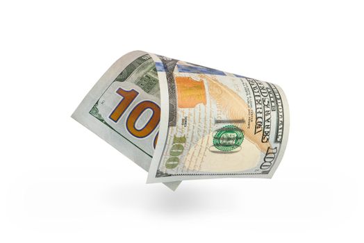 Hundred dollar bill falling casting shadow, half-folded bill close-up on white background.