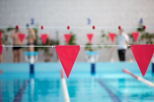 An empty sports pool with a red dividing path. Blue water in the swimming pool.