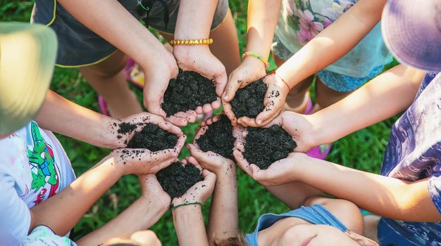 Children hold the earth in their hands. Selective focus. nature.