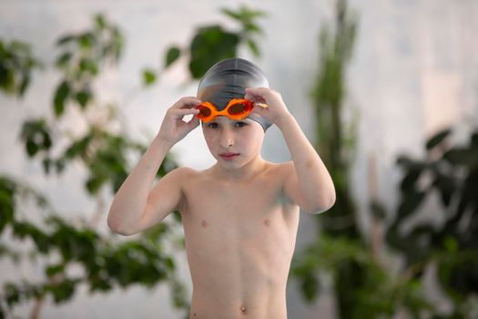 Boy in a swimming cap in the sports pool.