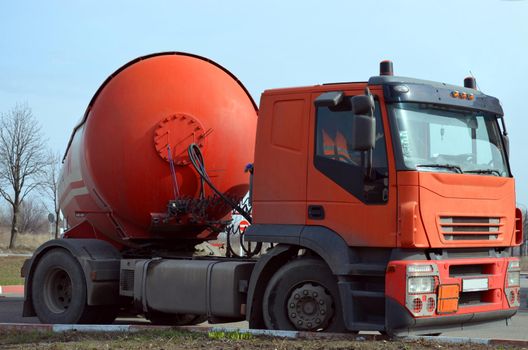 Gasoline tanker red fuel tank. Oil trailer, truck on road. Transportation fuel