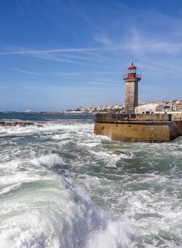 lighthouse at Atlantic ocean with big wave. download photo