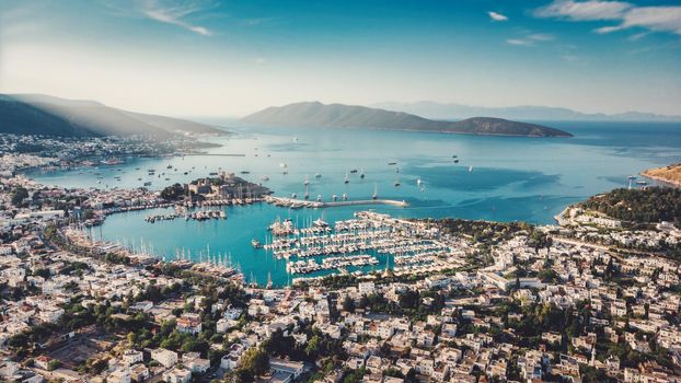 Beautiful European town in greece style on summer sea coast. Natural panoramic landscape view sky, mountains, water, city houses, ships and boats amazing seascape. Beautiful Mediterranean seascape. High quality photo