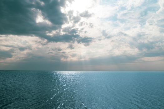blue sea and cloudy sky over it. Blue Sea sky and Clouds with sun behind. beautiful background