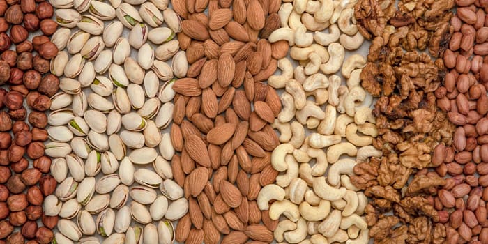 Nuts background, top view. The natural background is made from different varieties of nuts.