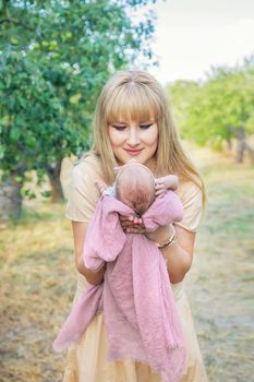 Mom with a newborn baby in her arms. Selective focus. People.