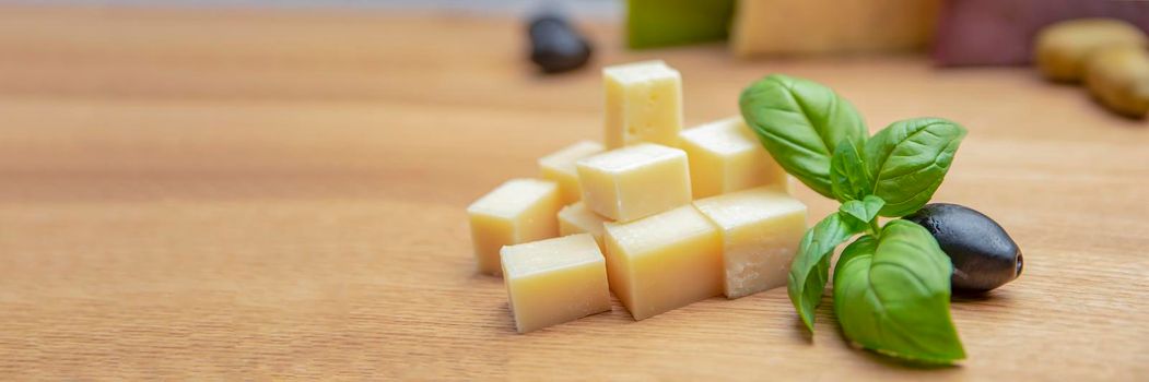 Cheese background. Assortment of different types of cheese on a wooden background.Place for text.