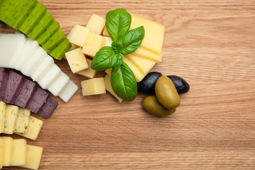 Cheese background. Assortment of different types of cheese on a wooden background.Place for text.