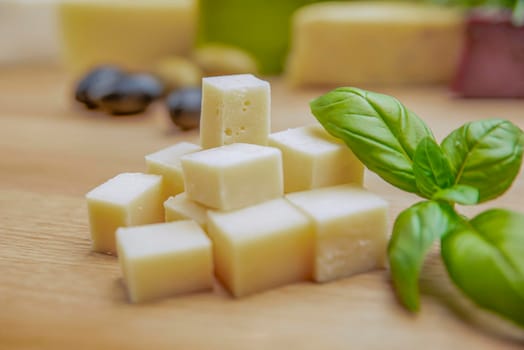 Cheese background. Assortment of different types of cheese on a wooden background.Place for text.