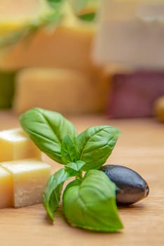 Cheese background. Assortment of different types of cheese on a wooden background.Place for text.